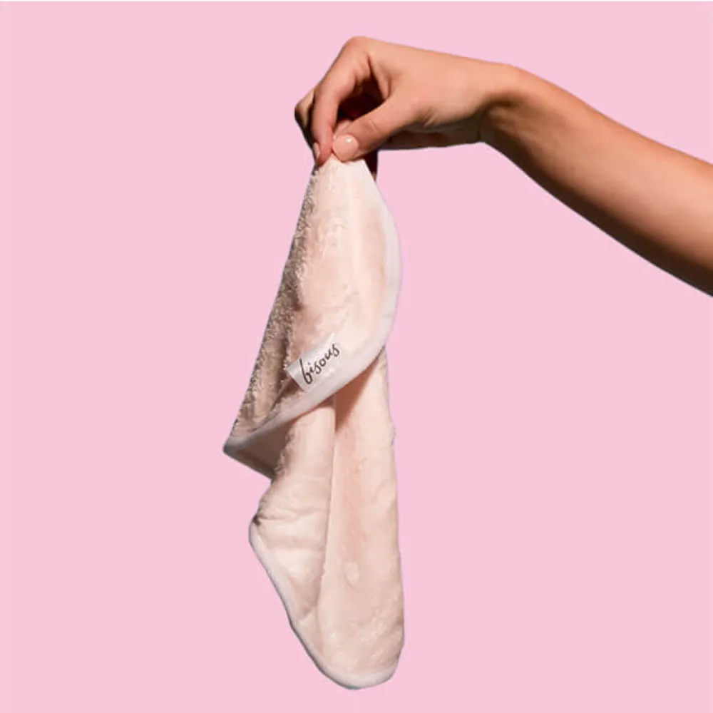 Bisous Cloth in Nude Pink held up against a pink background